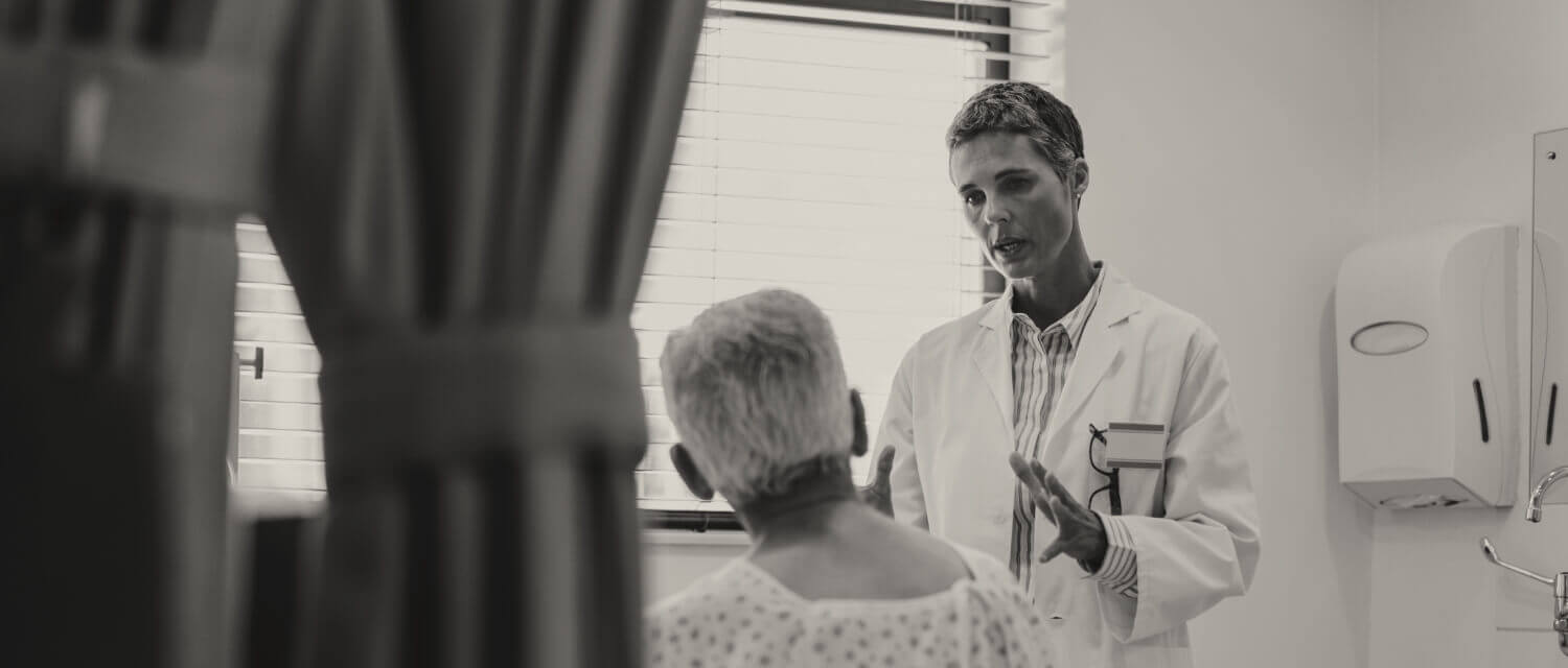 Doctor speaking with hospital patient case study image